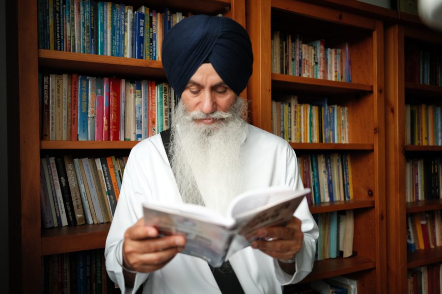 Bhai Sahib Singh (Canada Wale) reading by his library